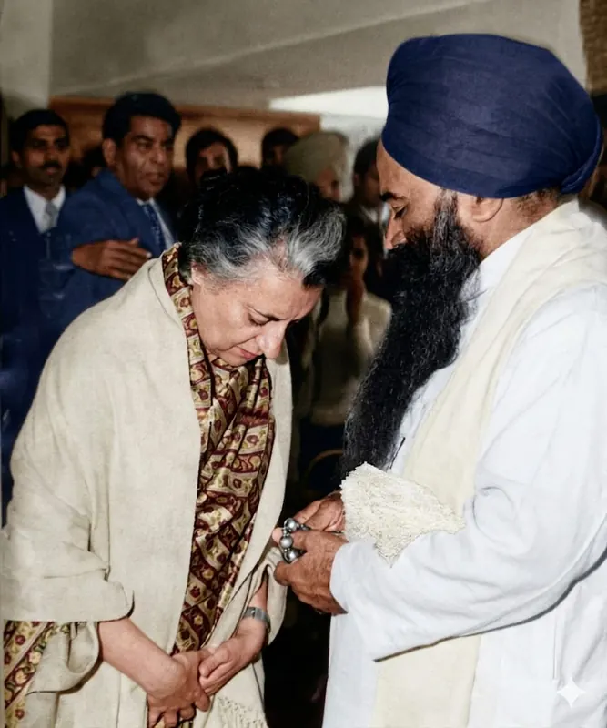 Indira Gandhi standing close before him, her head bowed, his hands clasped over hers.
