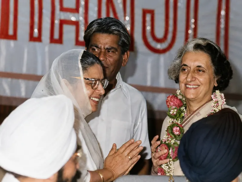 His wife greeting a garlanded Prime Minister Indira Gandhi at a reception.